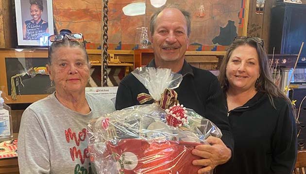 Winslow resident Greg Hackler (center) was the winner of the Winslow Woman’s Club basket raffle. Proceeds from the raffle garnered $500 that was provided to Alice’s Place from the Woman’s Club. Also pictured is Bert Cole (left) with the Woman’s Club and Theresa Warren (right), the director of Alice’s Place.