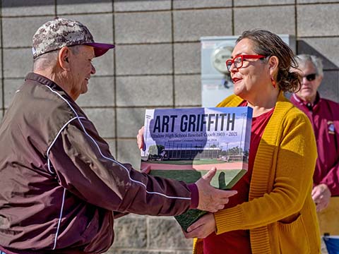 Mayor Birdie Cano (right) presented Coach Art Griffith (left) with an award from the city in the shape of a baseball base.