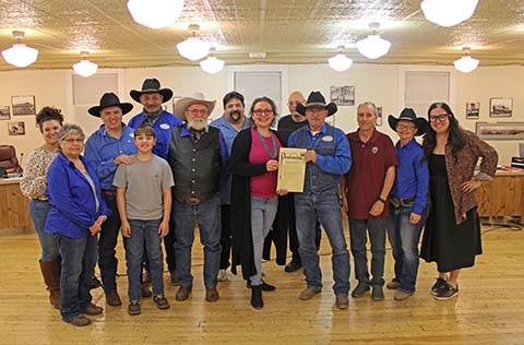 Members of the Clear Creek Cowboys along with Mayor Birdie Cano (center presenting proclamation) and Clear Creek Cowboys Association President Tim Kelley (right of Cano) stand with members of the Winslow City Council during a proclamation made by the council in the group’s honor.
