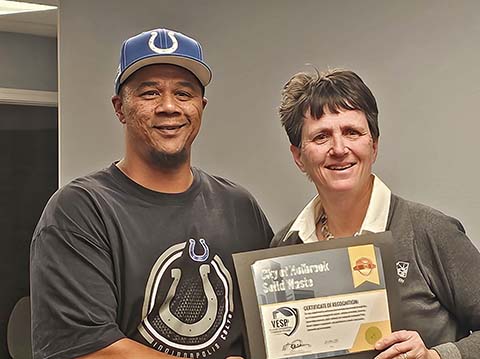 Sam Hollins (left) with the city’s sanitation department accepted an award on behalf of the department from the Arizona Department of Environmental Quality (ADEQ) for three years of consecutive excellence. Mannie Bowler (right) presented the award, which was earned by the department’s consistent compliance, as well as going above and beyond ADEQ requirements.