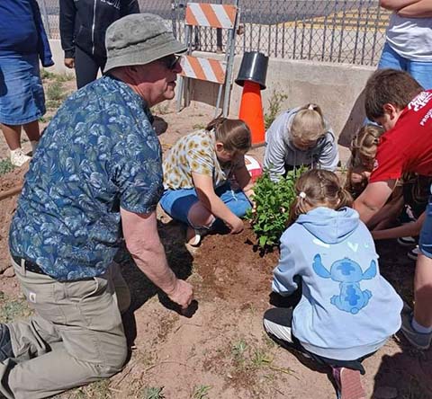 Last week students at Joseph City Elementary School, under the direction of Principal Darrell Mosier (left) planted a lilac bush as a memorial to April Sartain-La Grange. Sartain taught for 17 years at Joseph City Elementary and passed away in April of last year.