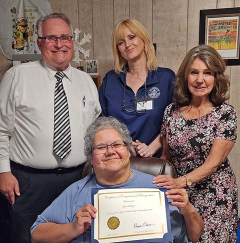 Last week Lisa Salazar (seated), the director of Holbrook Extended Care, was recognized for her 39 years of exemplary service to the senior citizen community of Holbrook by the Congressional Office of Eli Crane. Pictured are (left to right) Mike Nilsson, Holbrook Senior Center president, Lori Mills, representative of Congressman Eli Crane, and Twyla Taylor, a member of the Holbrook Senior Center Board of Directors.