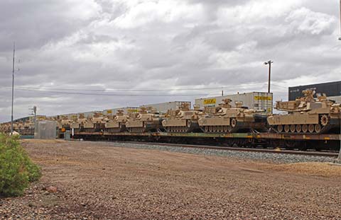 This train in Winslow carrying military tanks and equipment was one of many that came to an unexpected halt following a derailment near Chambers, east of Holbrook along I-40. The incident, which involved no reported injuries, caused significant disruption including shutting down I-40 east to traffic for two days as authorities worked to secure the site and assess the situation.