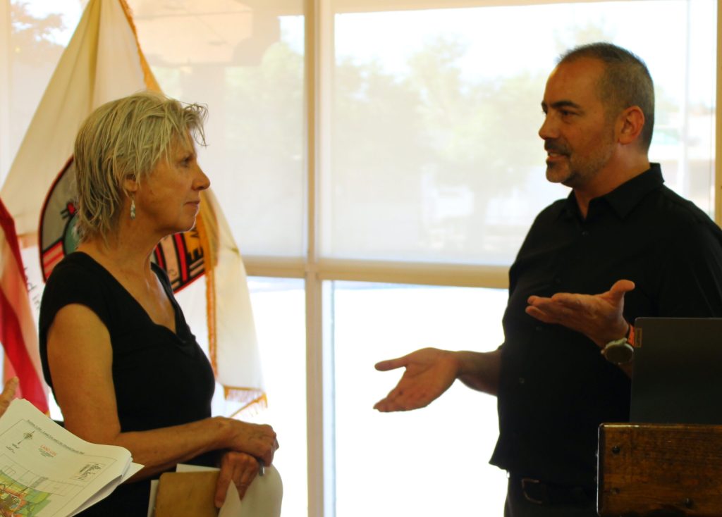 Resident Ann Schmidt (left) speaks with Winslow’s Planning and Zoning Officer Jason Sanks (right) during the public viewing of the land maps included in the newest edition of the city’s general plan.