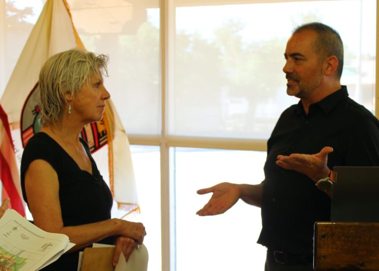 Resident Ann Schmidt (left) speaks with Winslow’s Planning and Zoning Officer Jason Sanks (right) during the public viewing of the land maps included in the newest edition of the city’s general plan.