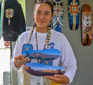 Di’Orr Greenwood shows off her Nike collaboration shoes at the Smithsonian Folklife Festival in Washington, D.C, June 24, 2024.
