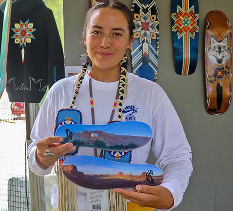 Di’Orr Greenwood shows off her Nike collaboration shoes at the Smithsonian Folklife Festival in Washington, D.C, June 24, 2024.