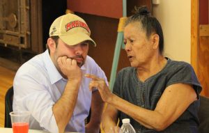 Ruben Gallego (left) sits with Winslow resident Lula May Staygo (right) and discusses tribal issues.