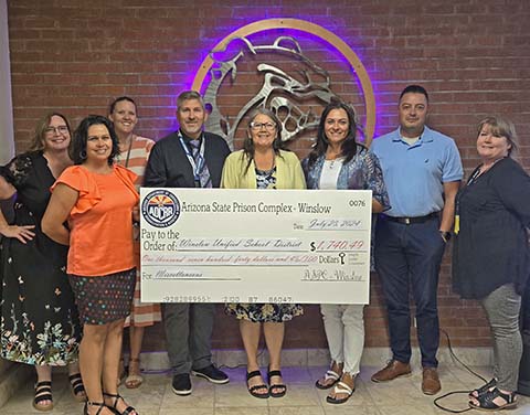 Accepting a check from Arizona State Prison Complex-Winslow were (left to right) Amanda Leonard, Amber Martinez, Larissa Richards, Warden Stephen Morris, Superintendent Connie Gover, WHS Vice Principal Kourtney Hendricks, WHS Principal Sal Hernandez and ASPC Wendy Eccles.