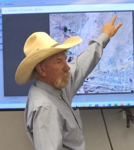 Landowner Casey Murph shows council members where the transmission lines for the Snowflake Solar LLC project will cut across city-owned land and a portion of his land.