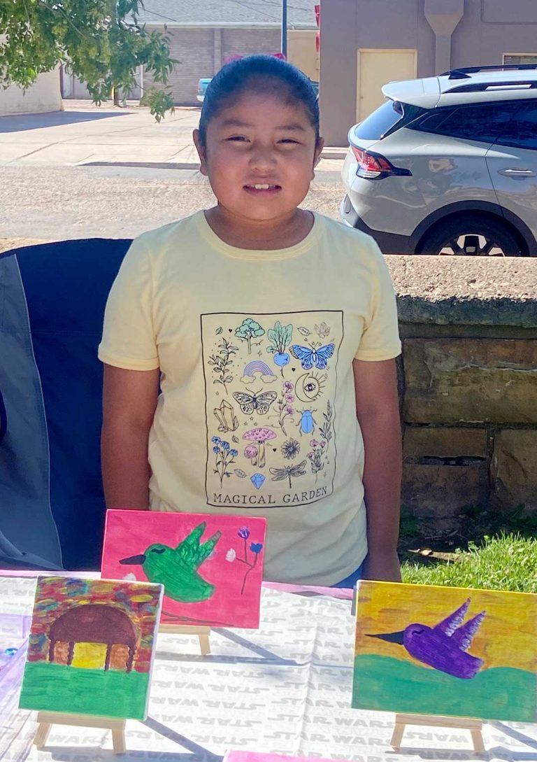 Young Zoey Bitsui shares her artistic skills by selling her painting at the Farmer’s and Artisan Market.