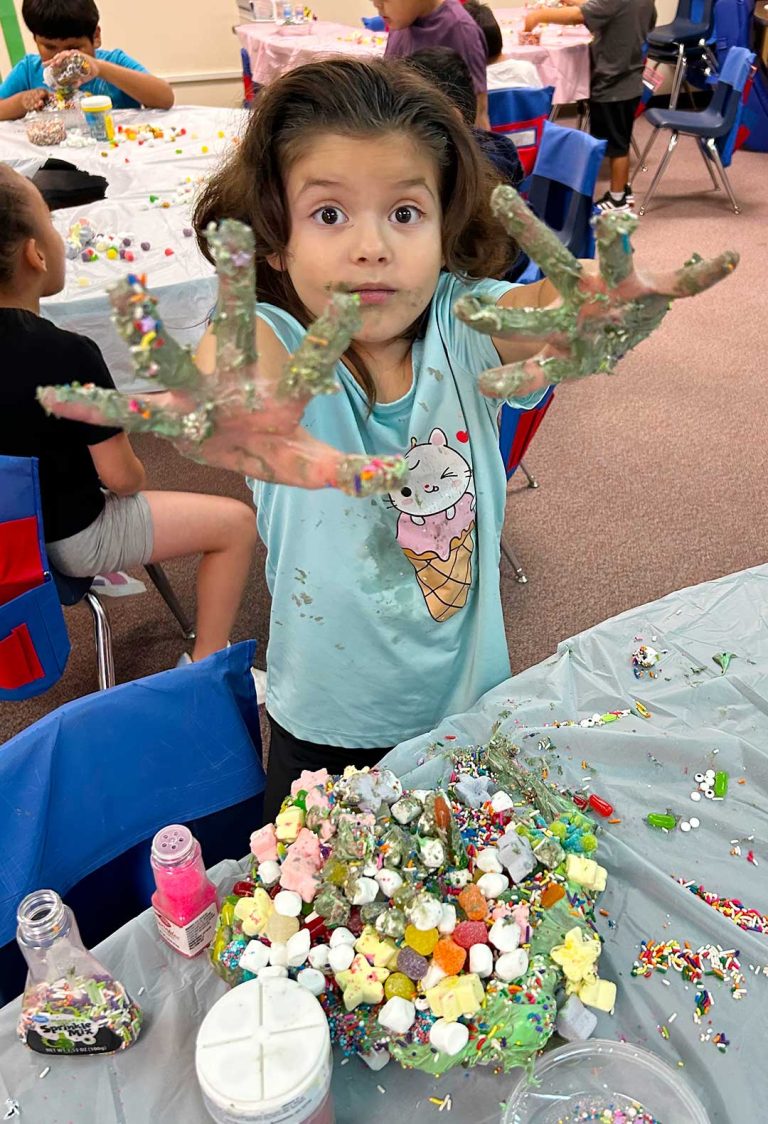 Aradessa Quintana from Brianna Allison’s HELP (Holbrook Educational Learning Program) class at Park Elementary School poses with her “ugly” cake for the upcoming fair.