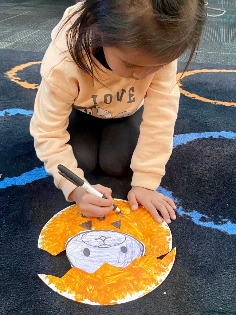 Kensie Nelson works hard making a pumpkin for her classroom bulletin board.