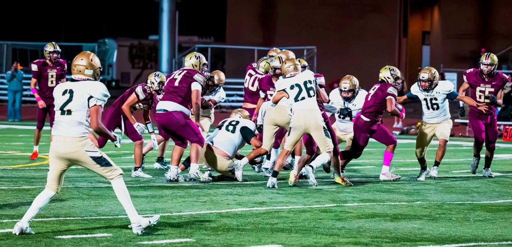 No. 9 Michael Romero-Cortez with the Bulldogs blasts his way through the Chinle defensive line for a large gain in Thursday night's football game. Bulldogs had a huge comeback win over Chinle.