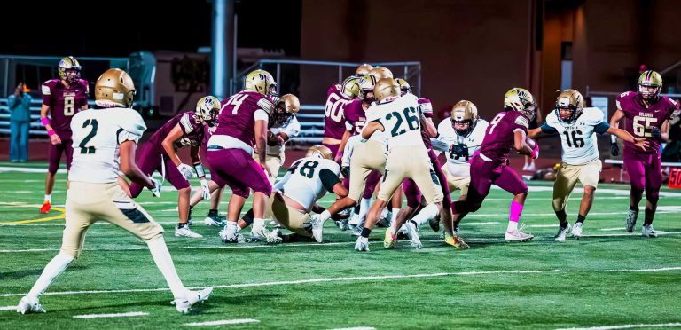 No. 9 Michael Romero-Cortez with the Bulldogs blasts his way through the Chinle defensive line for a large gain in Thursday night's football game. Bulldogs had a huge comeback win over Chinle.