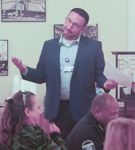 Travis Udall (standing), CEO of Little Colorado Medical Center, presented during Good Morning Winslow.
