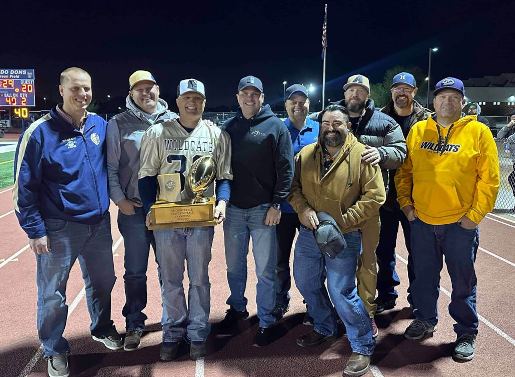 Members of the Joseph City High School 1999 1A football championship team came together earlier this month at their alma mater in celebration of the 25th year since their accomplishment. Pictured are (left to right) Dan Bushman, TC Fish, Nolan Martineau (holding the trophy won in 1999), JC Click, Kevin Martineau, Bo Lee, Rodney States, Jerry Miller and Eldon Larsen.