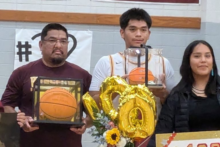 Isaac David (center) was honored last week for his basketball accomplishments. Also pictured are WHS Head Coach Venton Nelson (left) and David's sister, Jasmine Redhouse (right).