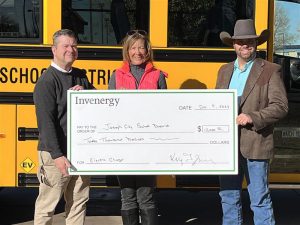Presenting a check to cover the cost of an electric bus charging station to Joseph City Unified School District is Invenergy Manager of Local and Community Affairs Kelly Zagrzebski (center) pictured with JCUSD Finance Manager Steve Mills (left) and JCUSD Transportation Coordinator Spencer Johnstun (right).