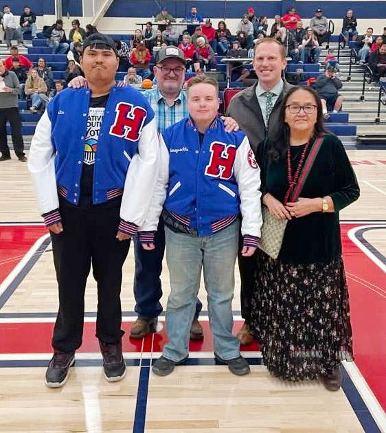 Justin Beall (left) and Kyle Honeysuckle (second from left) were recognized at halftime of the Roadrunner basketball game last week for their outstanding achievement in Special Olympics! Both were presented with Holbrook High School letterman jackets. Also pictured are (left to right) HHS Teacher Cary Simpson, HHS Principal Clete Hargrave and HUSD Board Member Linda Yazzie.