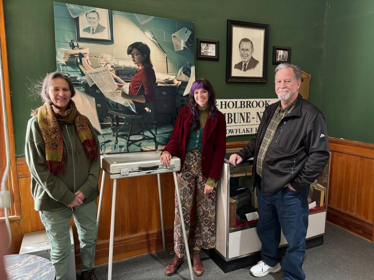 The Navajo County Historical Museum has added the work of local artist Talaina Kor (center) to the newspaper exhibit featured in the museum. Also pictured are Navajo County Historical Society President Sherry Reed (left) and former owner of The Tribune, Matthew Barger (right).