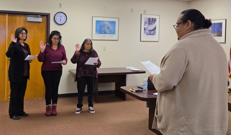 Todd Wilcox (right) swears in, from left to right, Debbie Martinez, Janice Childers and Isabel Britton to the Winslow Unified School District Governing Board.