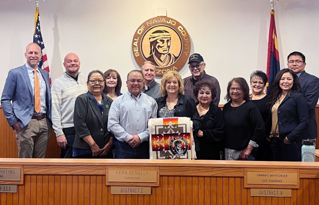 Deanne Romo (center) with her husband Tommy, member of her family and the Board of Supervisors after being honored for her nearly 44 years of employment with the county, the last 14 years as Clerk of the Court.