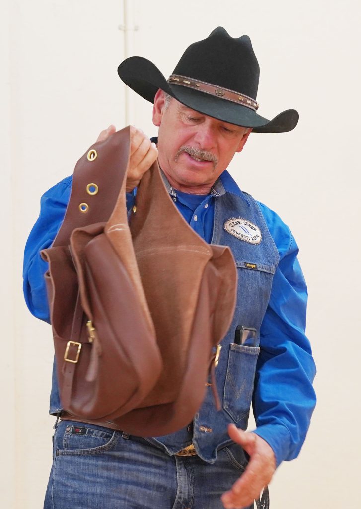 Clear Creek Cowboys President Tim Kelley shows the Winslow council his new letter carrying bag he will be using for the ride.
