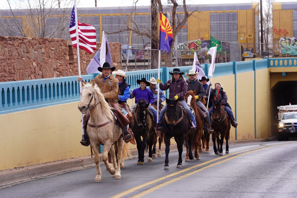Carrying their flags, the Clear Creek Cowboys ride through the underpass on Williamson Avenue in Winslow to mark the end of their journey from Holbrook. Pictured are (left to right) Tim Kelley, Enrique Pacheco, Mica Diaz, Alejandro Pacheco, David Ramos, Jason Harris, JR Perez and Tammy Gray.