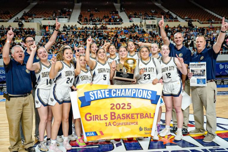 The Lady Wildcats celebrate as they bring the state championship title home to Joseph City last weekend. The team, under the direction of Coach Dan Bushman, had a stellar season. Pictured are (front row left to right) Assistant Coach Danny Hutchens, Jorja Hutchens, Jackie Richards, Jaydiana Kinlicheenie, Sammy Jesmer, April Neill, Gabby Jesmer, Kaci Palmer, Head Coach Dan Bushman, (second row) Assistant Coach Micah Brawley, Mariah Miller, Raylee Fish, Amber Neill, McKenzie Jesmer, Audrey Neill, Tori Beatty and Assistant Coach Aaron Neill. In an unusual circumstance Sammy and Gabby Jesmer are twins, Audry and Amber Neill are twins, and each set have a sister also on the team.
