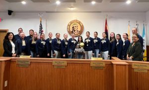 The Joseph City High School basketball team was recognized by the Board of Supervisors last week for winning the 1A state championship. Those pictured with the team and coaches include board Chairman Dawnafe Whitesinger (left), Supervisor Alberto Peshlakai (third from left) and Supervisor Fern Benally. Addressing the board during the meeting was team coach, Dan Bushman (second from left).
