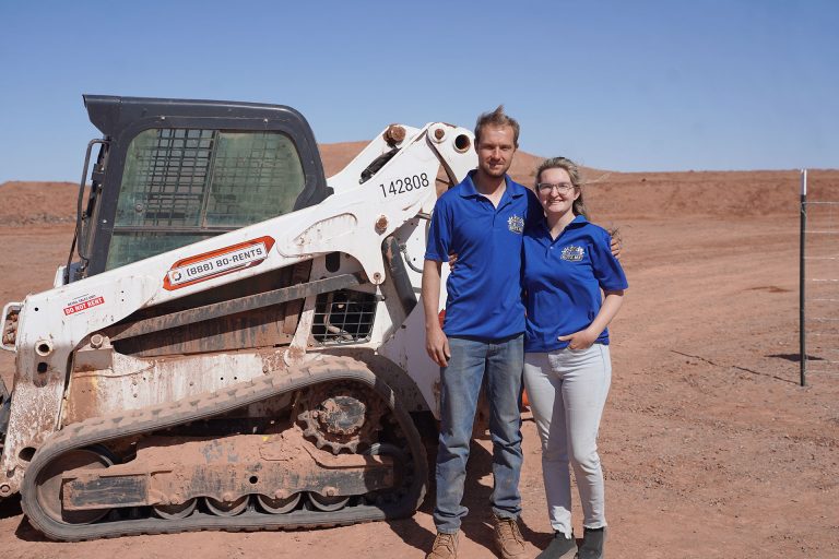 Daniel and Hailee Hutchins of Joseph City stand proudly in front of the professional course at Rutz MX, their newly opened motocross track in Holbrook.