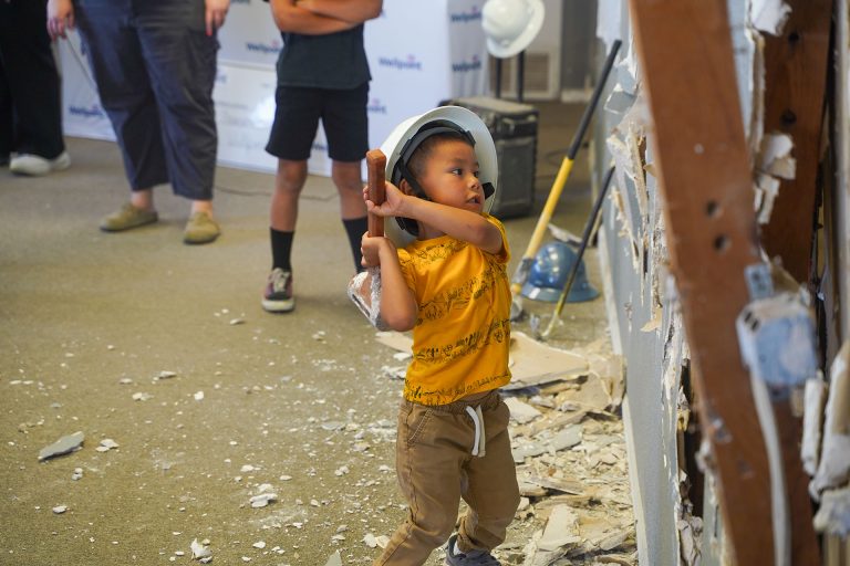 Holbrook resident Tanner Begay stepped up to take a swing at a wall to start the remodel for the Bijou (pronounced ‘bee zhoo’) Teen Center in Holbrook. This center will serve local teens with a wide variety of services.