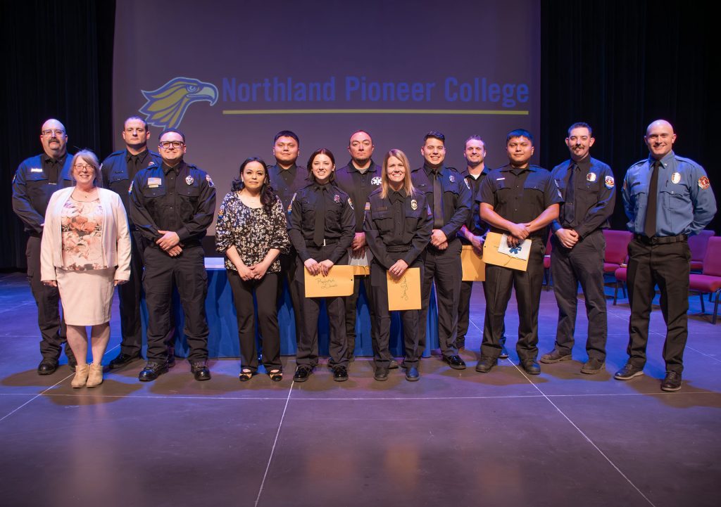 Graduates from NPC's 2024-25 EMT/Paramedic program join the program’s instructor, Michelle Prentice, to receive their paramedic patches and certification. Pictured are (left to right) James Meek, Michelle Prentice, Ryan Short, Julian Mendoza, Timathea Ethelbagh-Amos, Daniel Larzelere, Rebekah Daniels, Adam Fisher, Lacie Davis, Kristofer Torres, Derek Daley, David Larzelere, Ryan Carpenter and Ben Knight.