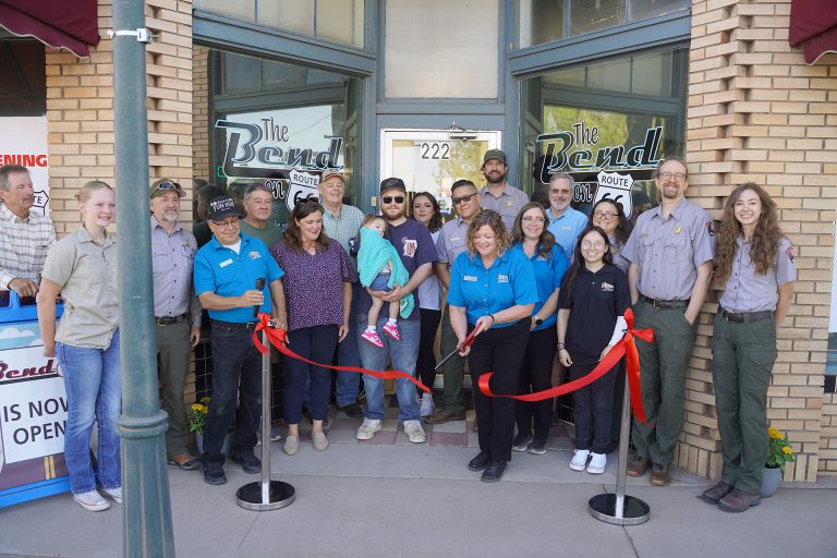 Tara Young Executive Director of the Petrified Forest Museum Association cuts the ribbon on their new storefront. Members from the association, the Petrified Forest National Park, the Friends of the Petrified Forest Foundation, the community and the Holbrook Chamber of Commerce all came out to celebrate the new space for people to enrich their love for their community’s national park.