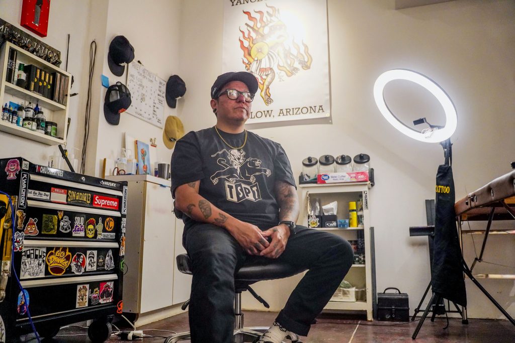 Tattoo artist and painter Yancey Katoney sits inside his Spotted Toad Tattoo Shop at Broken Focus Studio in Winslow, the creative space he now shares with fellow Native artists Randall and Cheri Sahmie.