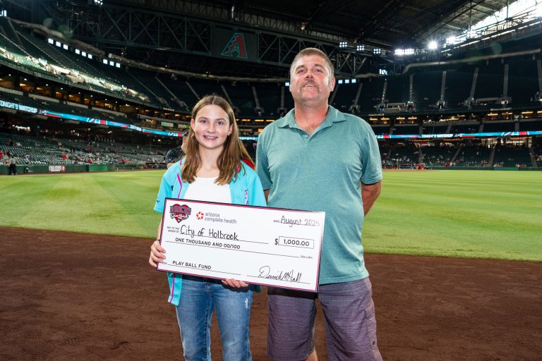 The City of Holbrook was honored as a 2025 Play Ball Fund grant recipient, presented by Arizona Complete Health and the Arizona Diamondbacks Foundation. As part of the celebration, City Manager Randy Sullivan (right) and youth athlete London Gardner (left) had the opportunity to step onto Chase Field and accept the award before the Diamondbacks faced off against the Cleveland Guardians on Aug. 19. This $1,000 grant recognizes the city’s dedication to supporting youth athletes.
