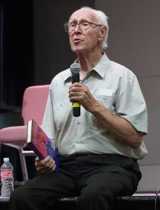 Holocaust survivor Dr. Dirk van Leenen speaks on stage at the Winslow High School Performing Arts Center last week, sharing stories of his family’s resistance in the Netherlands during World War II.