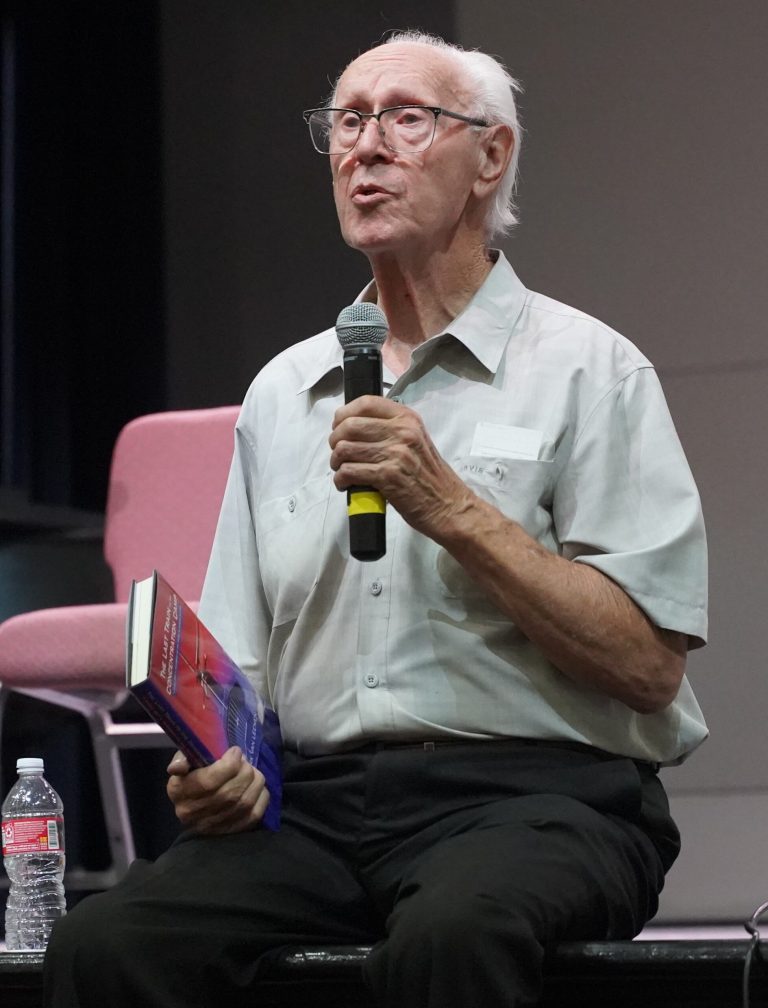 Holocaust survivor Dr. Dirk van Leenen speaks on stage at the Winslow High School Performing Arts Center last week, sharing stories of his family’s resistance in the Netherlands during World War II.