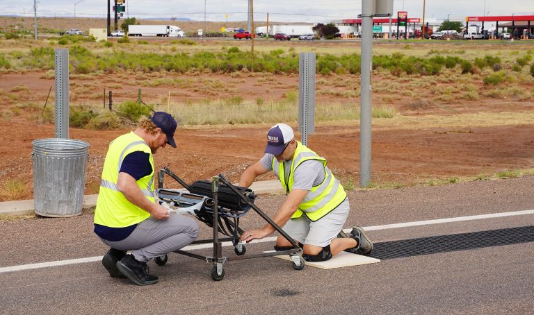 Tim Arnold (right) and Nick Blair (left) of Road Tunes install a stretch of musical rumble strip along Route 66 in Winslow. When driven over at 35 mph, the strip plays the “Standin’ on the corner in Winslow, Arizona” portion of Take It Easy.