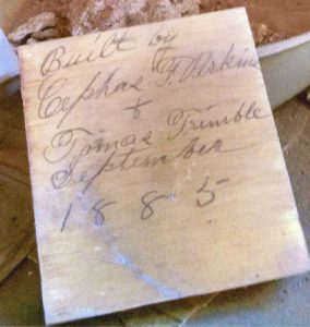 A block of wood discovered during renovation bears the signatures of Cephus Perkins and Tomas Trimble, two prominent early Holbrook residents who built the home in 1885.
