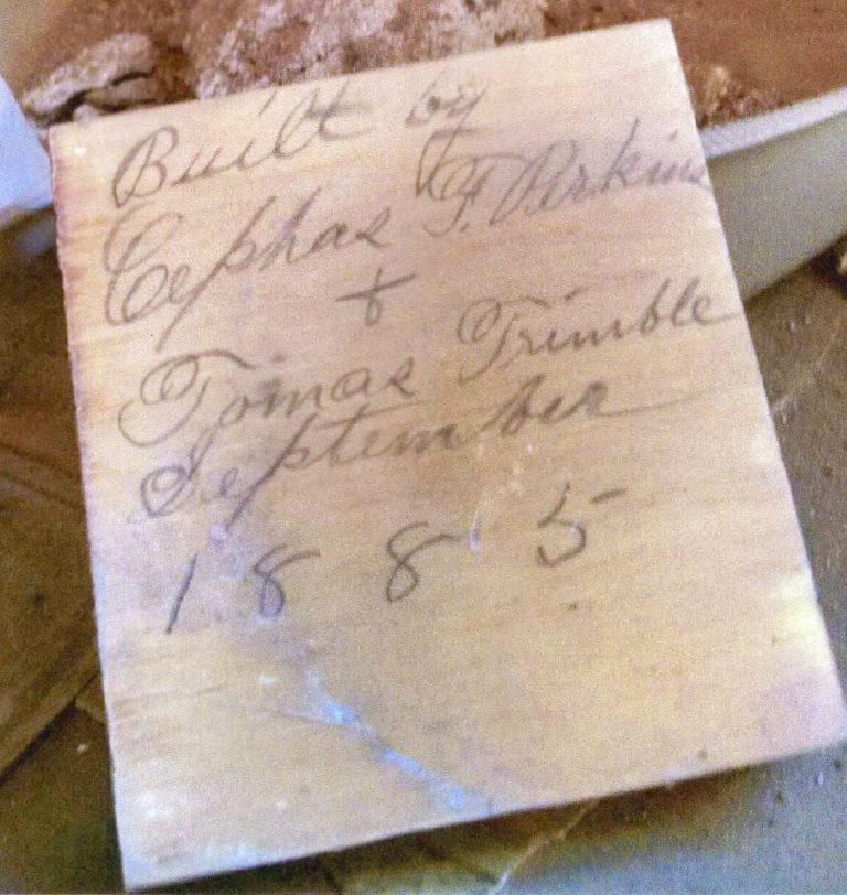 A block of wood discovered during renovation bears the signatures of Cephus Perkins and Tomas Trimble, two prominent early Holbrook residents who built the home in 1885.