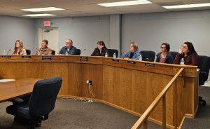 Holbrook Council members (left to right) Roxanne Pergesen, Robert Black, Vice Mayor Mike Nilsson, Mayor Kathleen Smith, Teri Tafoya, Karina Pack and Arcenia Pacheco listen to a presentation by SEI Realty’s David Mills.
