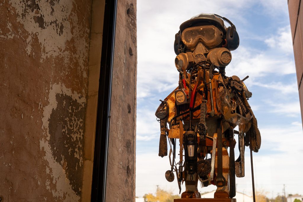 A body-shaped sculpture assembled from everyday objects, including a watch, a roll of tape and other salvaged materials, showcases Dan Lutzick’s signature approach to turning discarded items into form.