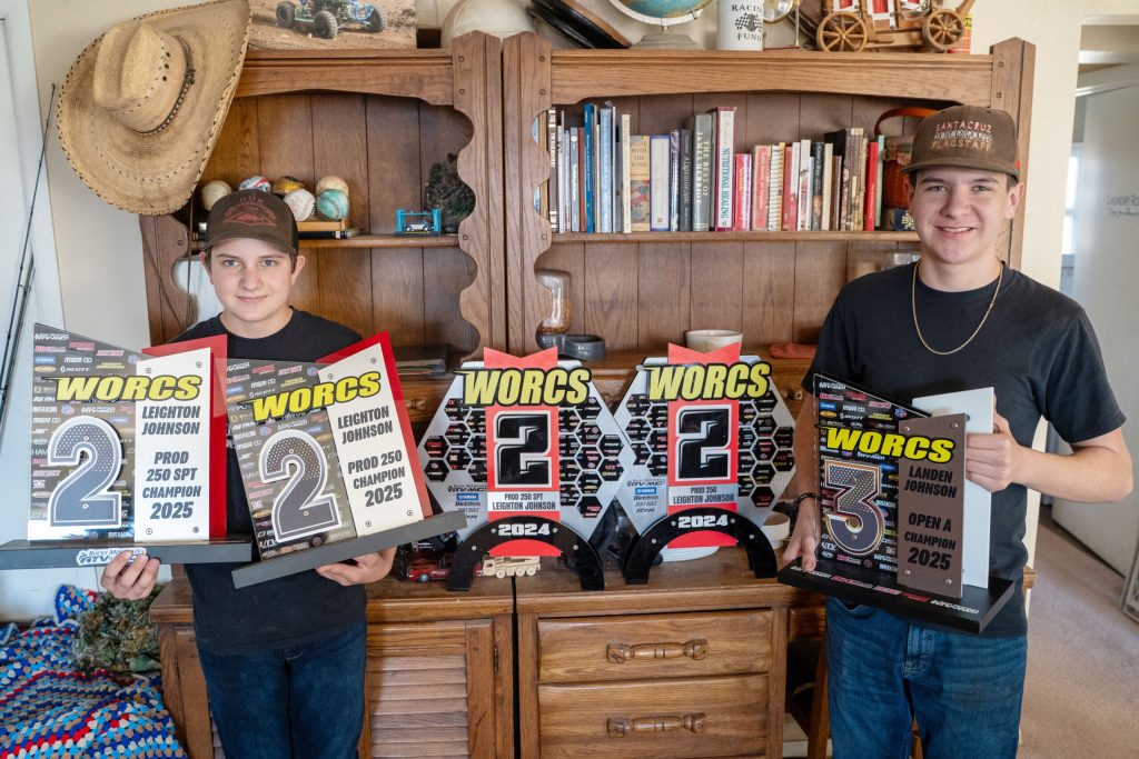 Lane Johnson (left) and his brother Landen (right) display their 2025 season-long awards alongside trophies earned in previous racing seasons.