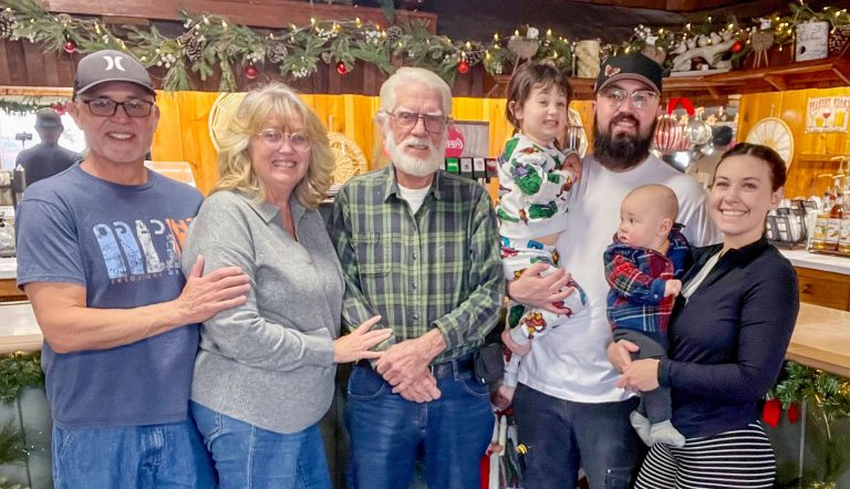 Inside Route Sixty Sipps in Holbrook, the family behind the shop gathers together. Pictured are (left to right) Paul Gonzales, Robin Gonzales, John “JW” O’Dell, baby Kora with Danny Gonzales and baby Lucky with Kaylee Bowman.