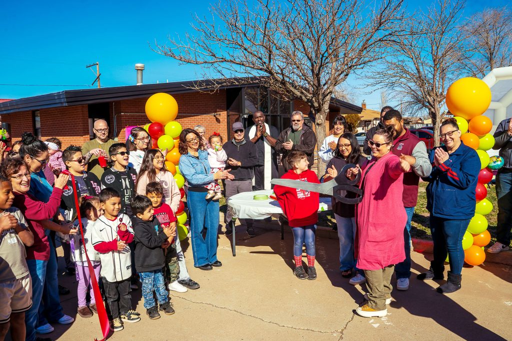 Community members and representatives of the Winslow Chamber of Commerce join Christina Gonzales-Jaramillo (holding scissors) during a ribbon-cutting ceremony Saturday at A Leap of Faith Learning Center, 723 N. Apache St., to celebrate the grand opening of the new child-care facility offering daytime, after-school, evening and weekend services in Winslow.