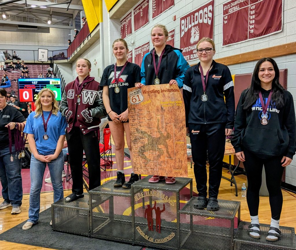 Winslow girls take the stage in the 138-pound weight class. Pictured are (left to right) Brooklinn Baldwin of Snowflake, sixth place; McKenna Hardy of Winslow, fourth; Nyla Naugles of Red Mountain, second; Brylee Colwell of Eastmark, first; Juliana De Marco of Poston Butte, third; and Julianna Arviza of Basha, fifth.
