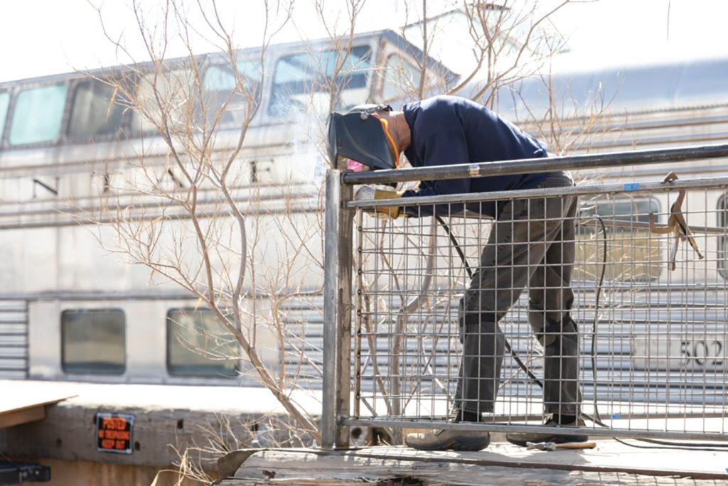 Sparks fly as metal artisan John Suttman welds the custom steel railing for the viewing platform surrounding the Santa Fe Super Chief “Pleasure Dome” in Winslow. The new railing will replace the chain-link fence and allow visitors to step up close to the historic railcar while the interior gets renovated. The train is one of six streamlined dome cars built by Pullman in 1950 for the Santa Fe Railway’s luxury Super Chief, which passed through the Painted Desert from 1937 to 1971. The Super Chief can be seen next to the La Posada Hotel, located at 303 E. 2nd St.
