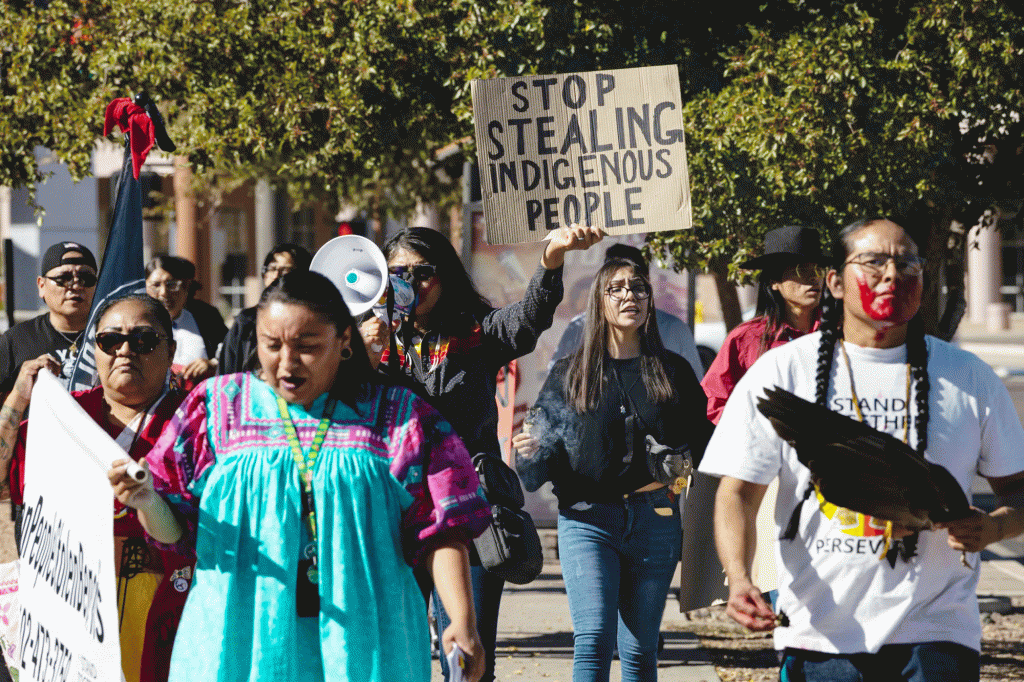 A group of volunteers with Turtle Island Women Warriors demonstrate outside the Arizona Capitol in November 2024 to raise awareness about Indigenous community members displaced by the state's massive Medicaid fraud scheme.